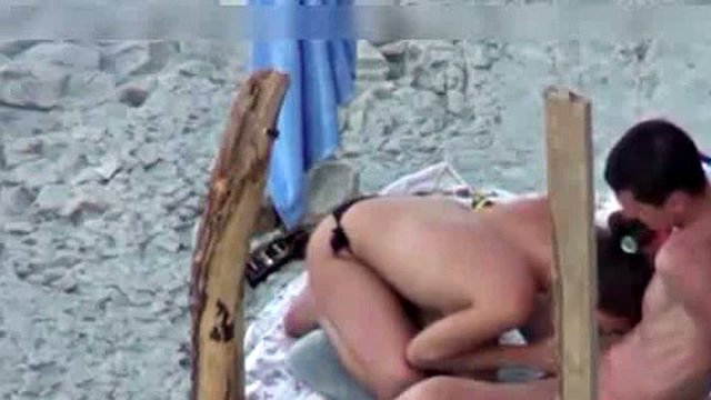 A couple is spying on camera at the beach