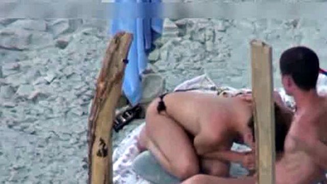 A couple is spying on camera at the beach