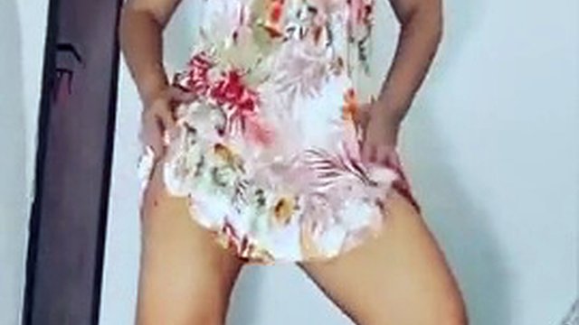 MirellaDelicia female dog dancing in a printed dress and white panties, wiggling hot, doing a striptease