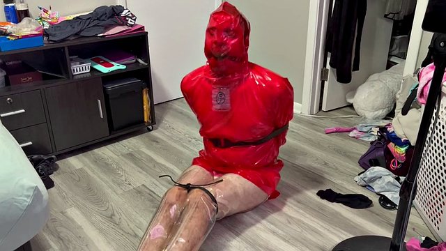 Bound and gagged plays with red plastic cape and clear boots