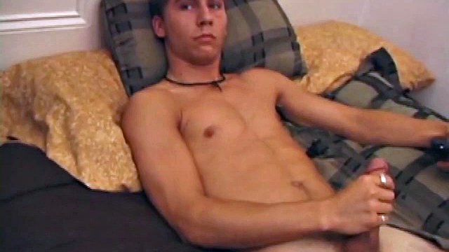 After storing his load for about a week, Brock is back to stroke one out for us. He makes himself at home on the bed, strips down and starts working his cock.