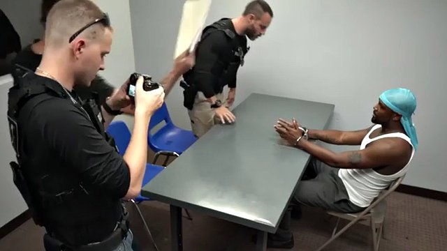 black thug gets a nice blowjob by white male and horny cop inside the police station