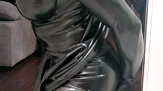 Rubber latex sissy in gas mask plays with a dildo