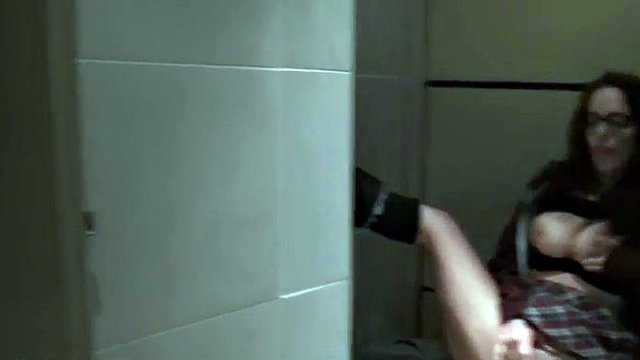 Busty nerd beauty masturbating in a public toilet